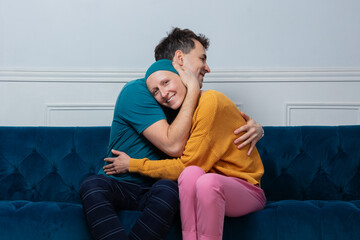 Pair, woman and man bonded in affection on their cozy sofa
