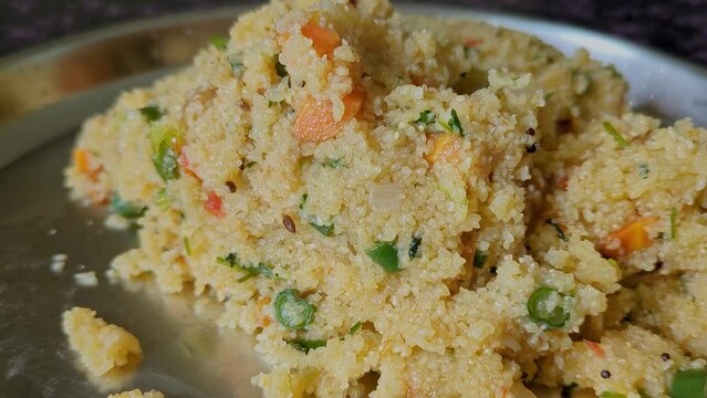 Close-up video of healthy homemade Indian breakfast broken wheat porridge or upma