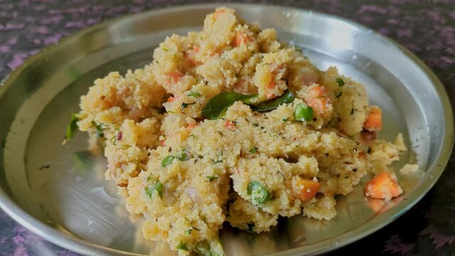 Close-up video of healthy homemade Indian breakfast broken wheat porridge or upma