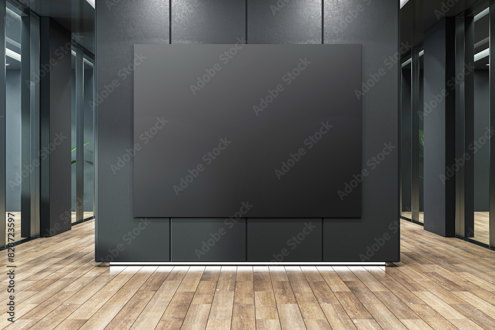Poster a black poster frame on a dark wall in a modern corridor with wooden flooring, concept of a blank mo