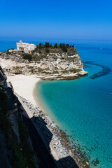 View of the beautiful beach with crystal clear turquoise water in Tropea, Italy.