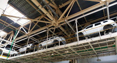 Industrial production of car automobiles. Plant for assembling modern cars on an assembly line. Industry, production, industry concept.