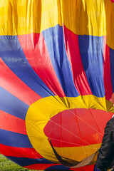  A man inflates a balloon at a balloon festival