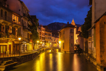 Annecy medieval historic city at night with mountain background, long exposure photography.