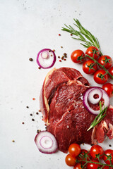Piece of raw meat beef with onion and seasoning, pepper and rosemary