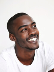 Obraz premium portrait of a black male model looking upwards with a bright smile and a plain white background