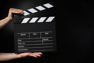 Hands with blackboard clapper, video clapboard, film industry, entertainment.