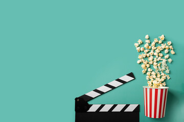 Popcorn with clapper board, salted snack for cinema, black clapperboard in production,green...