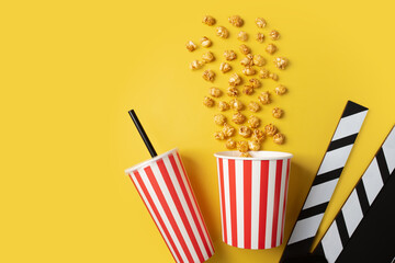 Popcorn sweet bucket with soda cup and Cinema clapper board, caramel pop corn in cup, video...
