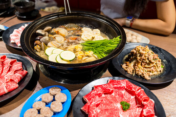 Hotpot with fresh slice of meat and seafood in restaurant