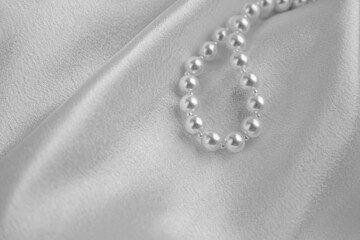 White pearls on white silk