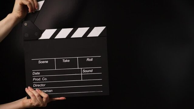 Hands with cinema board, marking the moment, film studio in operation.