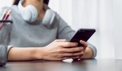 Woman holding a smartphone and using social media on internet.