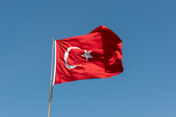 Flag of Turkiye. National flag consisting of a red field (background) with a central white star and...