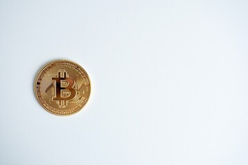 Gold bitcoin cryptocurrency isolated on copy spaced horionztal white background.