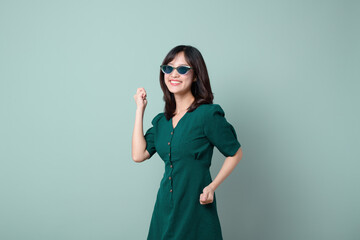 Asian woman green dress celebrated isolated on green background.