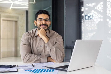 A business professional is diligently working in the office, utilizing modern technology and data...