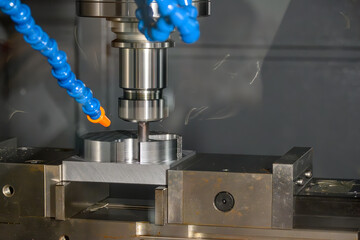 The CNC milling machine cutting mold parts with flat end mill tool in the light blue scene.