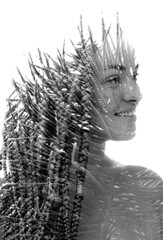 A double exposure portrait of a girl with braids merged with a photo of foliage