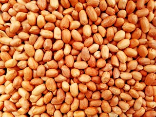 Peanut snack groundnut background pattern. Closeup whole peanut, roasted groundnut snack. Eating peanuts snack food concept. Peeled groundnut heap flat lay background. Salted peanuts top view texture