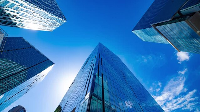 A timelapse of the cloud reflecting the mirror of the building in Tokyo wide shot