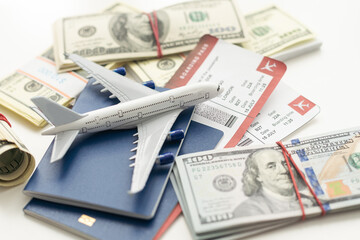 Airplane and money. Plane on the background of USA dollars. The cost of travel, air tickets and...