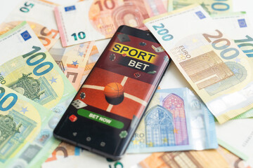 betting on sports, smart phone with working online betting mobile application