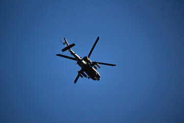 Military helicopter on a blue sky background