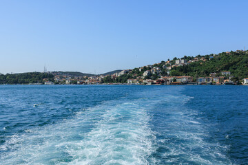 Fototapeta premium Turquoise blue sea water. View of the Bosphorus in Istanbul city on sunny summer day, in a public place.