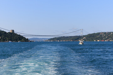 Fototapeta premium Turquoise blue sea water. View of the Bosphorus in Istanbul city on sunny summer day, in a public place.