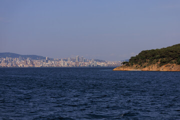 Fototapeta premium Turquoise blue sea water. View of the Bosphorus in Istanbul city on sunny summer day, in a public place.