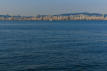 Turquoise blue sea water. View of the Bosphorus in Istanbul city on sunny summer day, in a public place.