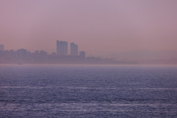 Pink and orange sky at sunset in the evening. Seascape overlooking the coast in the city of Istanbul