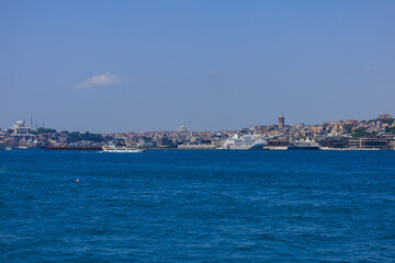 Fototapeta premium Blue seascape overlooking the coast. View of the Bosphorus in Istanbul city on sunny summer day, in a public place.