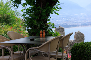 Beautiful views from above, tables in a cafe in the mountains and a panoramic view of the city, public places in Turkey, on a sunny summer day
