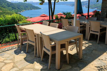 Beautiful views from above, tables in a cafe in the mountains and a panoramic view of the city, public places in Turkey, on a sunny summer day