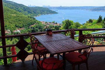 Fototapeta premium Beautiful views from above, tables in a cafe in the mountains and a panoramic view of the city, public places in Turkey, on a sunny summer day