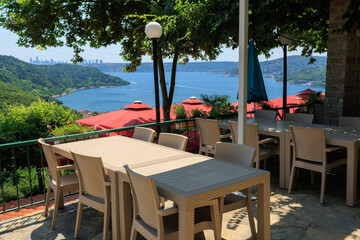 Beautiful views from above, tables in a cafe in the mountains and a panoramic view of the city, public places in Turkey, on a sunny summer day