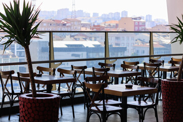 Beautiful views from above, tables in a cafe in the mountains and a panoramic view of the city, public places in Turkey, on a sunny summer day