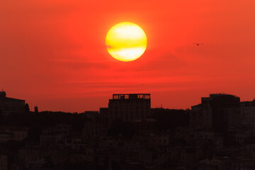 Orange sky at sunset in the evening. Silhouette and outlines of the buildings. Evening views of buildings of the city of Istanbul.