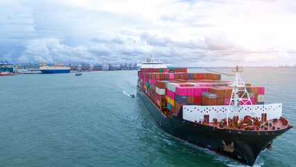 Side view of Cargo container ship carrying container and running out international container port...
