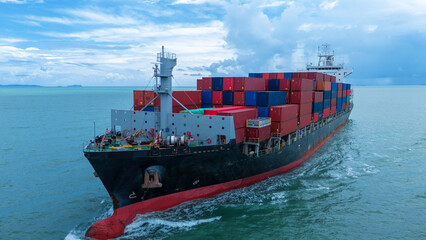 Side view of Cargo container ship carrying container and running out international container port...