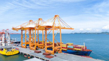 Crane loading box container to cargo ship at commercial dock port. Shipyard Cargo Container Sea...