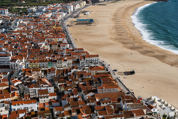 View from the hill to the sandy beach 'Praia da Nazaré' , Praia do Norte beach and Nazare town,...