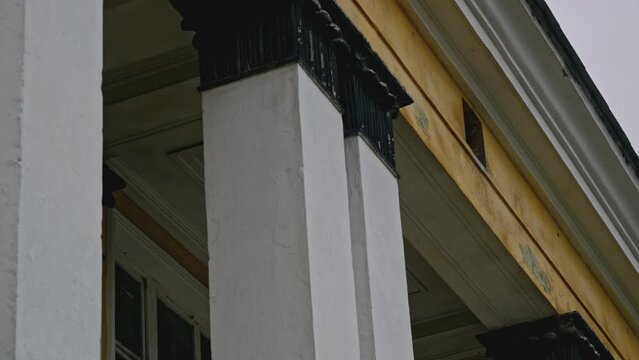 Abandoned 19th century palace with columns. Stock footage. Old manor house exterior.