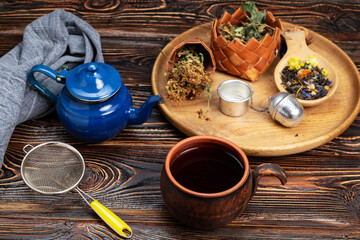 herbal tea and ingredients on wooden table