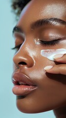 Woman with makeup, anti-aging glow, and closeup facial hydration creme in studio. Applying collagen, preventing acne, or figure with eyes closed on blue background