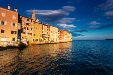 Wonderful morning view of old  Rovinj town with multicolored buildings and yachts moored along...