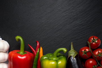 Colorful vegetables for healthy diet on black background with copy space.