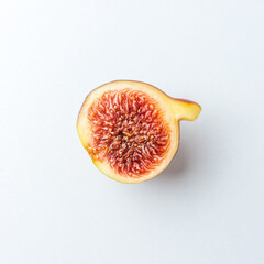 Ripe cut fig on white table. Food concept.